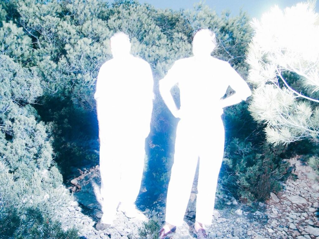 Soulwax duo David and Stephen Dewaele stand against a stark, modern backdrop, captured in moody lighting that reflects the experimental, futuristic tone of their upcoming album.
