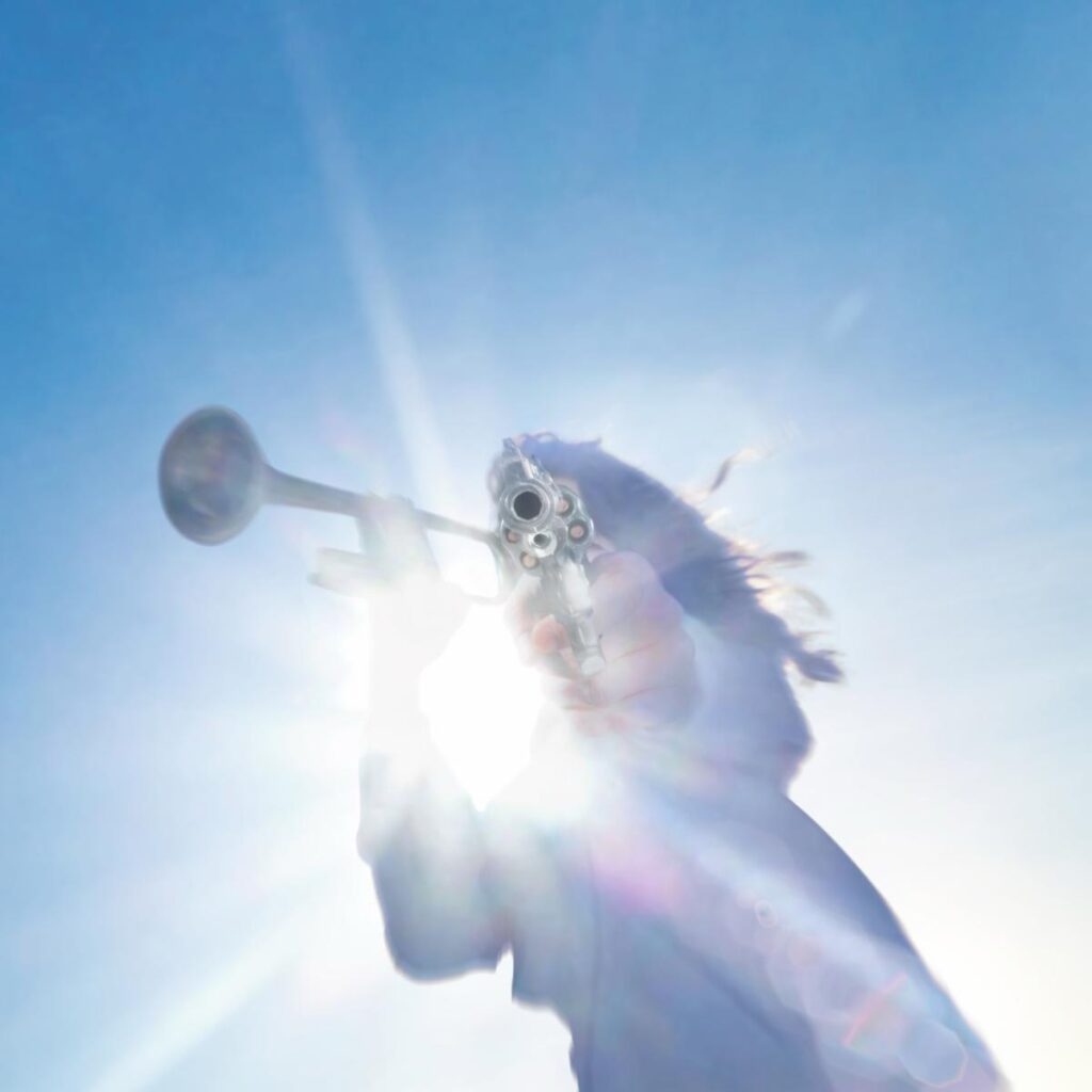 A stark, dramatic cover art for Geese’s Getting Killed album. A figure in white robes holds a trumpet in one hand and a handgun in another, set against a dramatic background — it’s unsettling, bold, and provocative. 